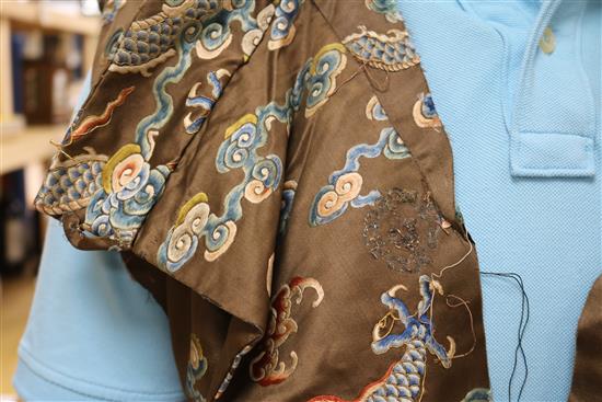 A Chinese black ground polychrome silk embroidered robe (a.f.)